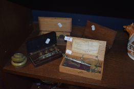 A variety of vintage and antique weights and two sets of scales.