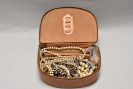 A small selection of mixed costume jewellery, rabbits foot brooch, etc with a leather covered case