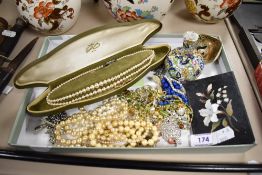 A selection of decorative costume jewellery and items, including white metal brooches, strings of