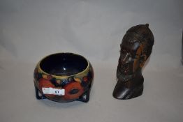 An early to mid 20th century Moorcroft bowl sat over three feet, having tube lined fruit design to