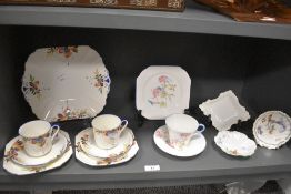 A mixed lot of Shelley ceramics, including Two Art Deco trios and a cake plate, with bright