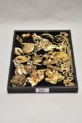 A tray of gold coloured decorative jewellery, to include brooches and chains, a circular brooch with
