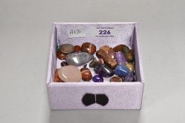 A small collection of polished cabochon stones to include agates
