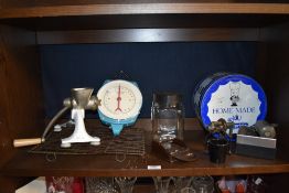 A collection of kitchenalia, including piping set, mincer and scales.