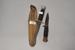 An early 20th Century William Rodgers dagger, with fullered blade, leather grip, and case, 26cm