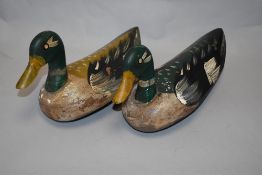 Two vintage wooden decoy ducks with painted decoration, some pellet marks.