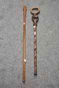 A mid-century African elephant walking stick, 90cm long, together with a tribal carved staff