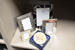Four photograph frames, of varying styles and sizes, and a vintage white metal lidded trinket dish