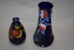 Two early 20th century Shelley vases, one of squat form with peach and grape design on dark blue