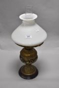 A Victorian pierced brass oil lamp, with conical glass shade, 51cm tall, together with four mantel