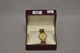 A gentleman's Rotary Artemis wristwatch, having a gold plated case and strap, with commemorative