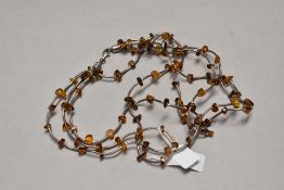 A four strand silver and amber collarette necklace