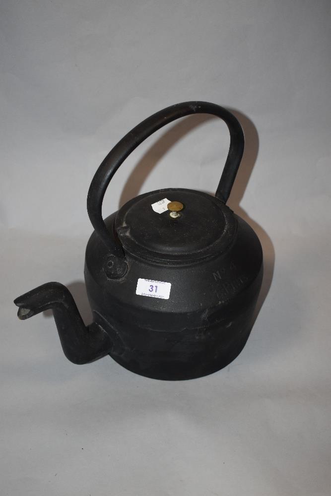A vintage cast metal eight pint kettle, marked Swain.