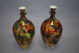 A pair of of Russell Akerman vases, of bottle form, with bright multi coloured glaze.
