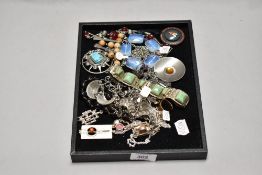 A collection of vintage and modern costume jewellery, including bracelets, rings and pendants.