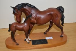 A Beswick pottery mare and foal study on wood plinth, Spirit of Affection,in matte finish.