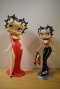 Two Betty Boop figurines, Betty in red dress and Betty shopping.