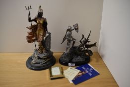 Two Royal Mint figurines, George and the Dragon and Britannia.