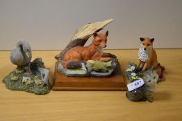 Four animal studies, including Beswick pottery cat and Aynsley Goose family.