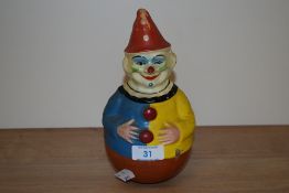 An early 20th Century papier mache Roly Poly clown with chime, possibly by Schoenhut, measuring 22cm
