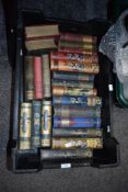 A collection of antique books, predominantly novels, most having highly decorative spines, including