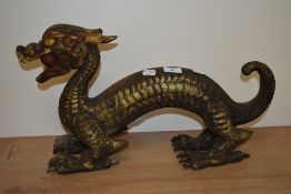 A carved gilt wooden Chinese dragon, measuring 52cm long
