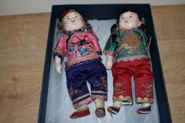 Two 20th Century Chinese pot costume dolls in traditional dress, measuring 27cm tall