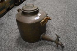 A large copper kettle with handle to mount on bracket and spout to base with tap.