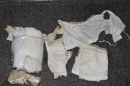 A Victorian babies gown, two pairs of gloves, a pair of sleeves, three unfinished bodices, one