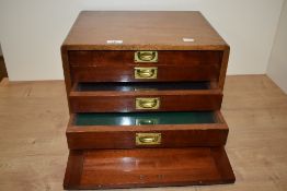 A 20th Century mahogany specimen cabinet, of military style, having four drawers and a fall front,