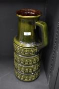 A mid-20th Century West German vase, green glaze, with a repeating geometric design to the body,