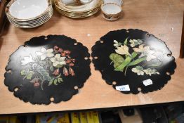 Two hand decorated early 19th century lacquered plaques, having floral decoration to each.
