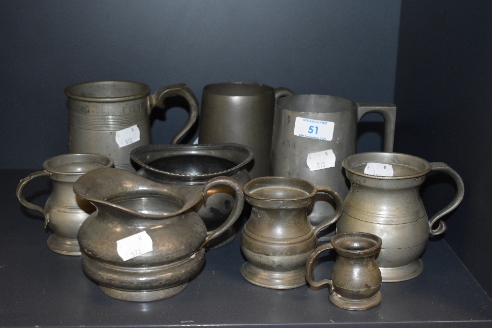 An assorted collection of antique pewter ware, to include tankards and measures