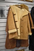 A vintage coney fur coat and two sheepskin jackets.