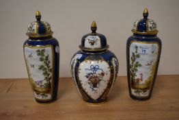 A pair of early 20th Century Aynsley lidded vases, each painted with scenes of exotic birds,