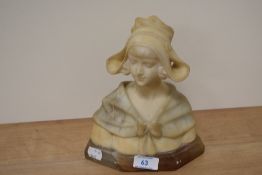 A Victorian alabaster bust of a young lady, raised on a stepped base, measuring 23cm tall