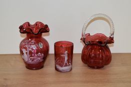 A 20th Century Fenton glass vase, of Mary Gregory style, a cranberry glass mug of similar style, and