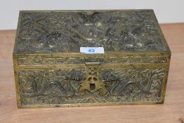 An early 20th Century Chinese brass repousse moulded jewellery box, measuring 10cm x 24cm x 15cm