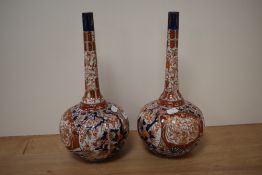 A pair of 19th Century Japanese Imari patterned bottle vases, measuring 37cm tall
