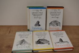 Seven editions of A pictorial guide to the Lakeland fells, by A Wainwright, books one to seven.