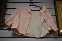 A 1940s pale pink bed jacket, believed to lined in WW2 parachute silk.
