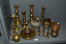 An assorted collection of Eastern and other brassware, to include candlesticks of alternate sizes,