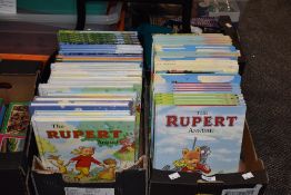 Two boxes of editions of the Rupert Annual.