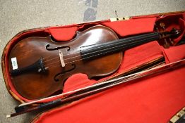 A traditional violn, over stained, with hard case and bow, unlabelled