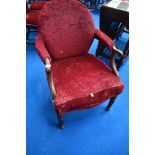 A Victorian mahogany easy chair having later burgundy upholstery and scroll arms