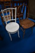 A traditional painted bentwood chair and a hoop and stick back dining chair