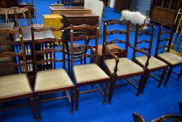 A set of six (five plus one) mahogany dining chairs having shaped ladder back and later