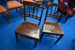 A pair of 19th Century solid seat dining chairs