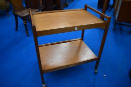 A vintage teak tea trolley