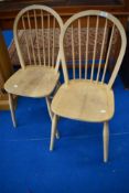 A pair of hoop and stick back kitchen chairs in the Ercol style
